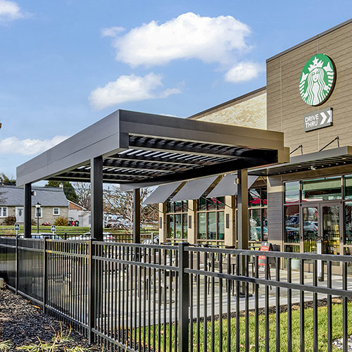 Starbucks terrace with an angled louvered roof by Azenco